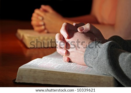 A Man And Woman Praying Together With Their Bibles - Male Foreground ...