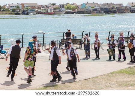 SHOREHAM, UK - JULY 18: Morris dancers demonstrating old English folk dancing to the public on Saturday, July 18, 2015 in Shoreham, West Sussex, UK