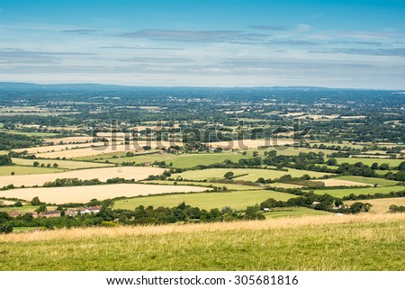 View of the South Downs way, view from the hills, East Sussex, England: fields and the houses