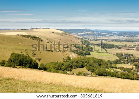 View of the South Downs way, view from the hills, East Sussex, England: fields and the houses