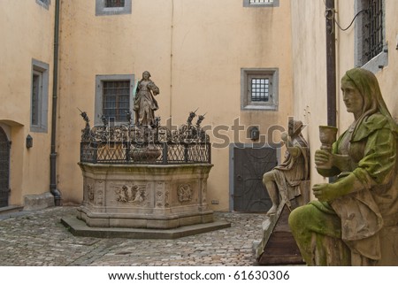 Yard with fountain and stone figures in the townhall of Regensburg, Germany