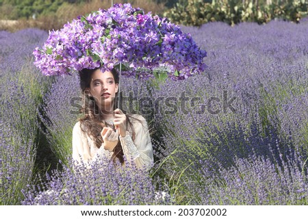 Beautiful Young Girl Outdoors in a Lavender Flower Field