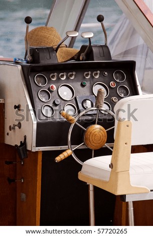 Motor boat interior with seat, wheel and control panel