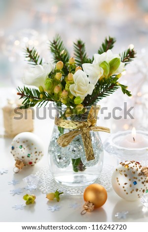 Christmas table decoration with flowers,gifts and baubles
