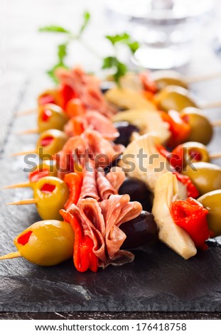 Antipasti skewers with olives,red pepper,artichoke hearts and salami