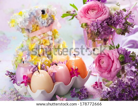 Colorful Easter candles and spring flowers