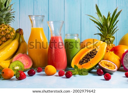 Assortment of fruits, berries and fresh drinks in jars on table. Summer healthy eating concept. Still life of food and drink.