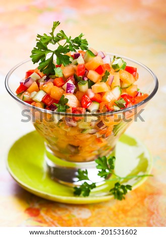 Fresh melon salsa with red pepper and cucumber