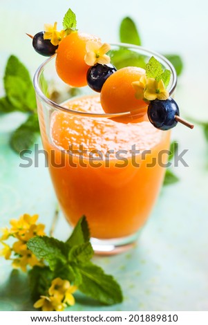 Melon smoothie with fruit skewer