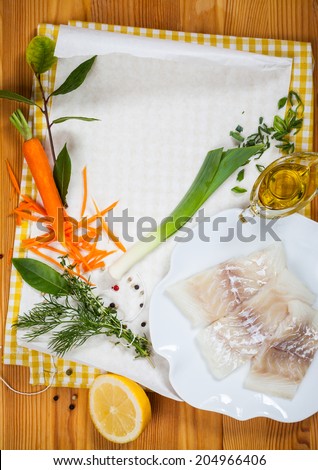 Cod fillets with vegetables before cooking in parchment paper