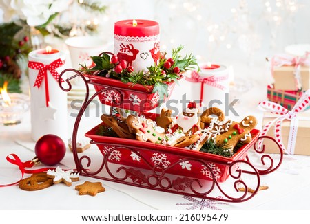Christmas table decoration with biscuits,flowers and candles
