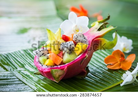 Exotic fruit salad served in half a dragon fruit