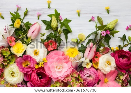 Photo of Flowers frame on white wooden background. Top view with copy space