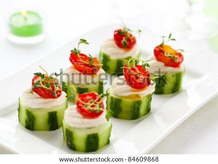 Holiday vegetable appetizers with cucumbers, soft cheese and sun dried tomatoes