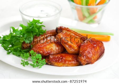 Buffalo chicken wings with blue cheese dressing and  carrot and celery sticks