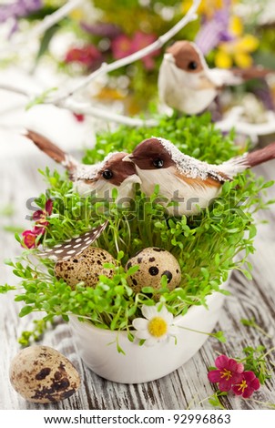 Easter decoration: birds and eggs on the fresh cress