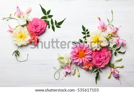 Photo of Festive flower composition on the white wooden background. Overhead view.