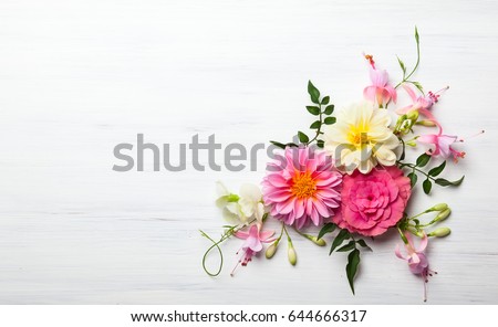 Photo of Festive flower composition on the white wooden background. Overhead view