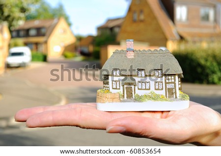 Small house in womans hand