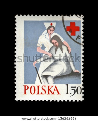 POLAND - CIRCA 1977, JAN 24: canceled stamp printed in Poland, shows nurse help old woman, Polish Red Cross, circa 1977. vintage post stamp isolated on black background.