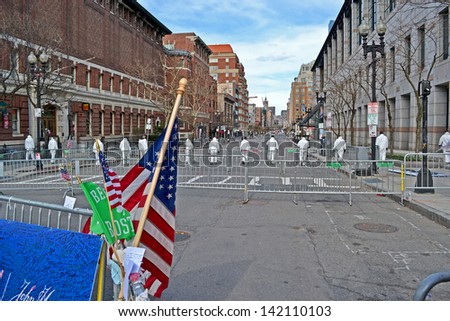 BOSTON - APR 20: People in white hazardous-materials uniform on Boylston Street in Boston, USA on April 20,2013. 3 people killed and over 100s injured during Boston Marathon bombing on April 15, 2013.