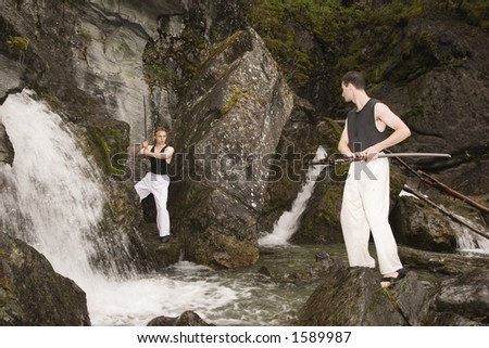 Waterfall area is a nice place to practice fencing outdoor. Two man with katanas