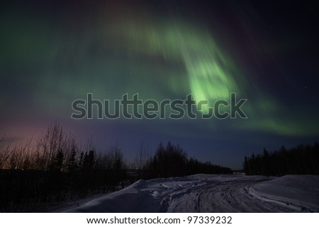 Active green-pink display of Aurora Borealis in Alaska