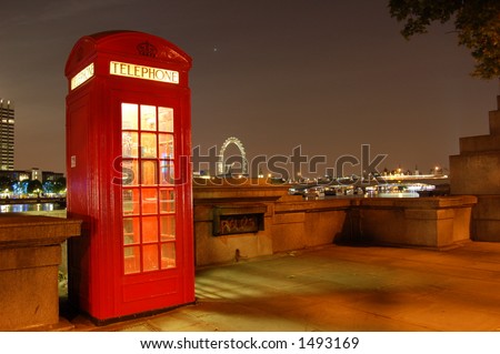 Traditional english phone booth with the London Center in the background