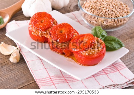 Stuffed tomatoes on a white plate.