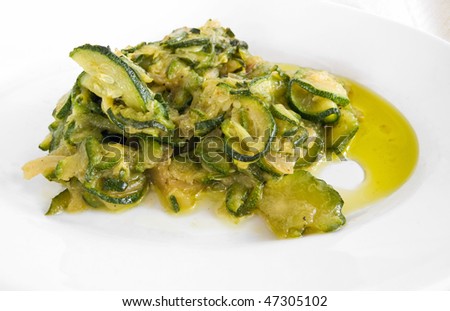 Courgettes sliced thinly and cooked with olive-oil and onions.