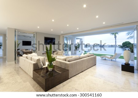 Beautiful living room with open doors to a yard viewing a big lake