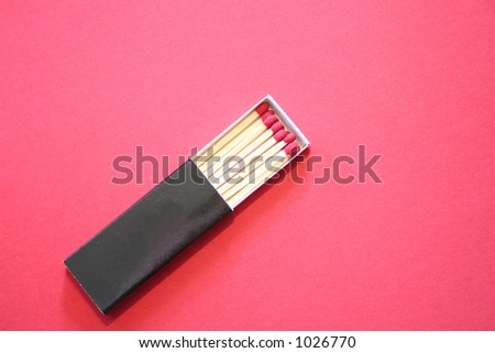 Red match sticks in a box on a red background.