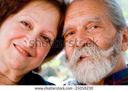 Old happy loving couple showing affection during retirement at their home