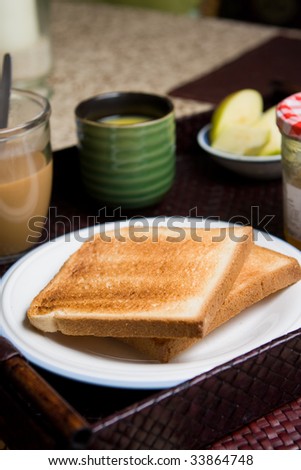 Breakfast meal with toast bread, coffee, orange juice, apples, marmalade