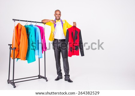 The man in the yellow jacket standing near the wardrobe jackets