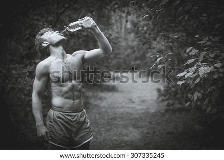 Man drinking water after running banks. Black and white photography