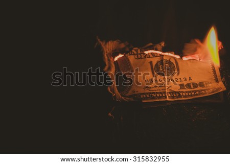 One hundred dollar bill on fire. Treatment with toning effect