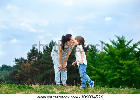 Loving son kissing his happy mother on the cheek