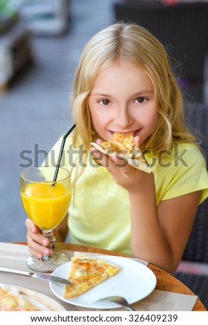 Pretty girls smiling when drinking juice and eating pizza