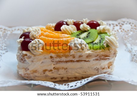 Whipped cream birthday cake with assorted fruit on white  napkin