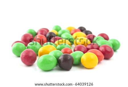 Pills with peanuts covered with multicolored glaze on a white background