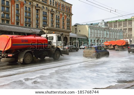 MOSCOW,RUSSIA - APRIL 6,2014:MAZ-based street sprinkler washes asphalt on Tverskaya Street . Moscows housing and utility services use various cleaning technologies based on weather conditions.