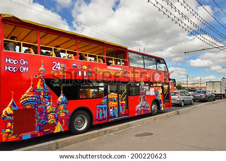 MOSCOW, RUSSIA - JUNE 22, 2014:Bright red double-decker tour buses are prowling Moscow\'s streets, giving visitors great view of city centre. Hop On-Hop Off tour offers excursions in eight languages