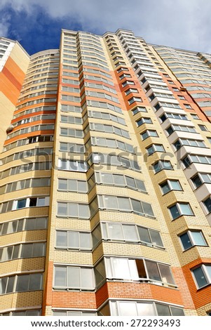 MOSCOW, RUSSIA - APRIL 22, 2015: Facade of  modern high-rise apartment buildings in Moscow on background of blue sky and white clouds, bottom view