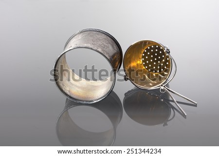 Silver tea strainer and napkin ring