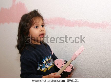 little girl with paint brush painting her room
