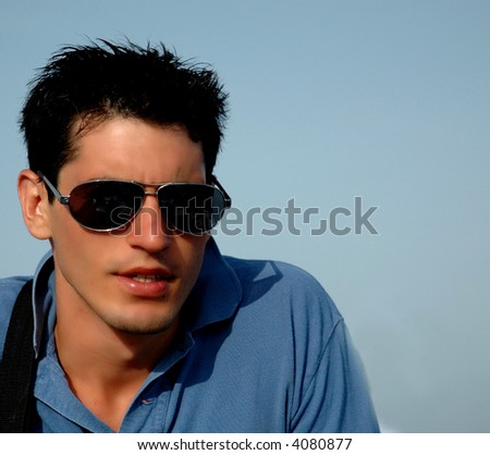 young attractive male in sunglasses about to talk