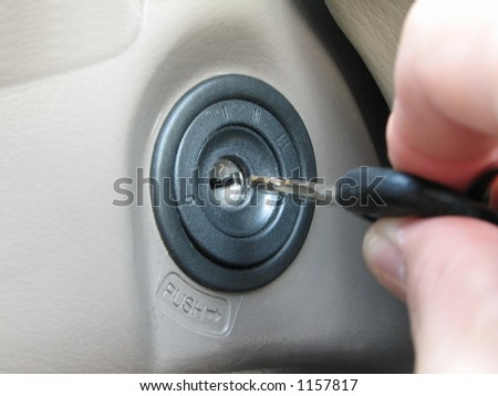 car key inserted into ignition slot and getting ready to start the car