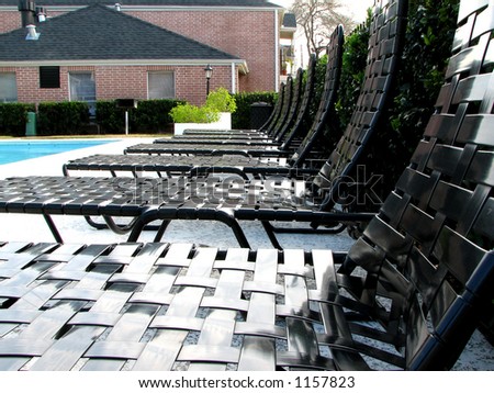 relaxation chair in the middle of swimming pool with building background