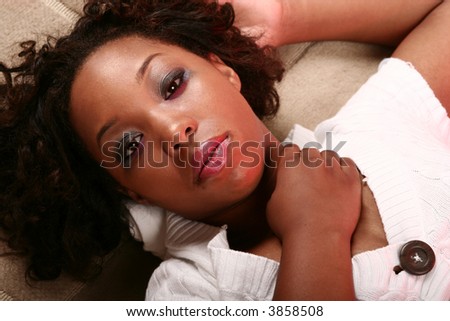 african american girl laying looking at camera and showing blank expression and sexy look